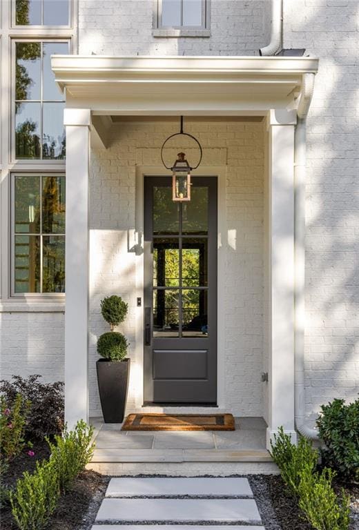 property entrance featuring brick siding