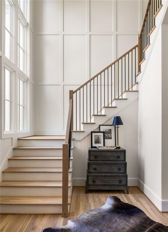 stairs with baseboards and wood finished floors