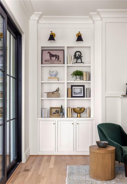 details featuring crown molding, built in features, and wood finished floors