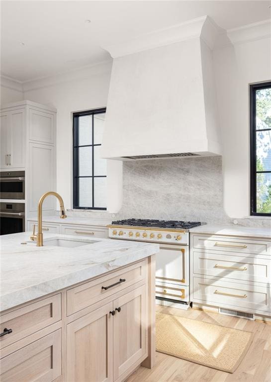 kitchen with crown molding, decorative backsplash, white range oven, and a sink