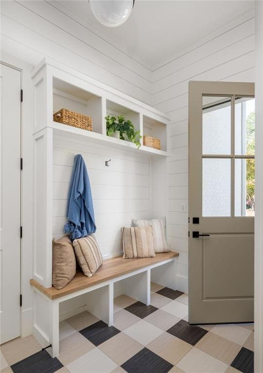 mudroom with light floors and wooden walls