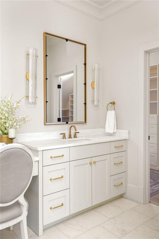 bathroom featuring ornamental molding, vanity, a spacious closet, and marble finish floor