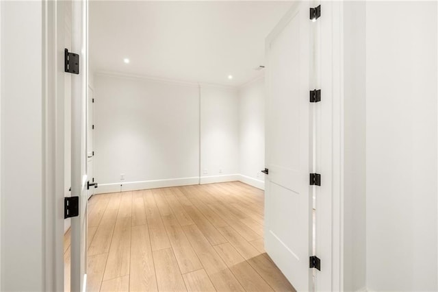 spare room with light wood-style flooring, baseboards, ornamental molding, and recessed lighting