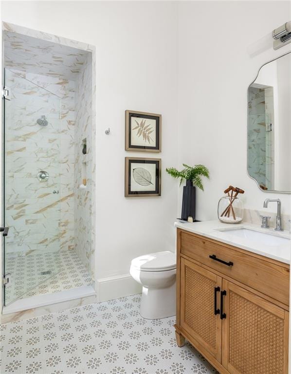 full bath with tile patterned flooring, toilet, baseboards, vanity, and a shower stall