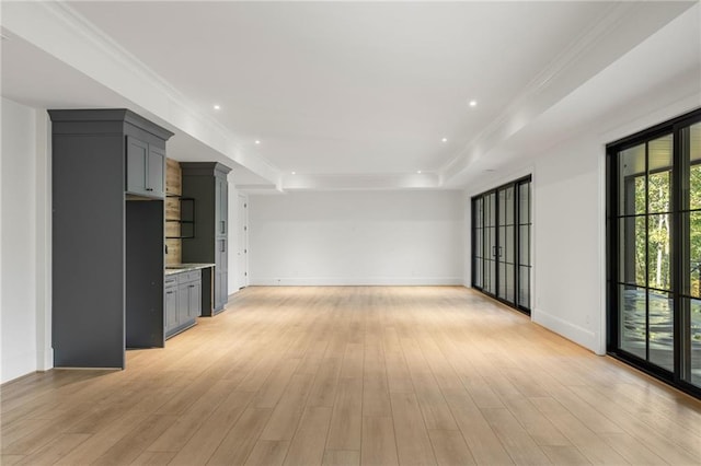 interior space featuring baseboards, ornamental molding, recessed lighting, and light wood-style floors