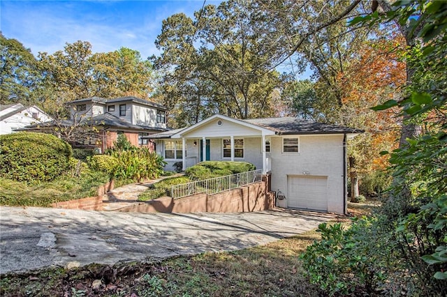 view of front of house featuring a porch and a garage