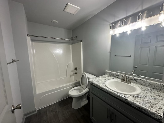 full bathroom featuring vanity, hardwood / wood-style floors, shower / tub combination, and toilet