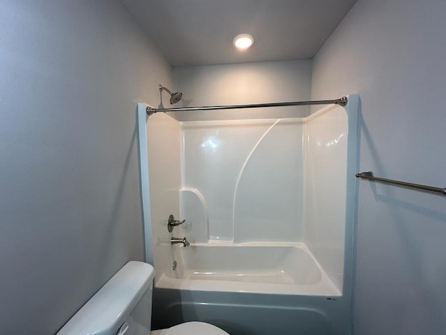 bathroom with bathtub / shower combination and toilet