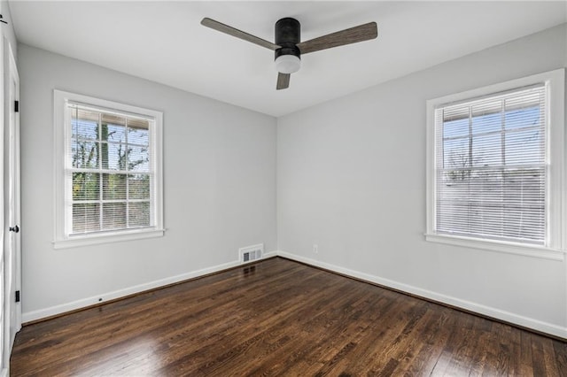 empty room featuring dark wood-type flooring and ceiling fan