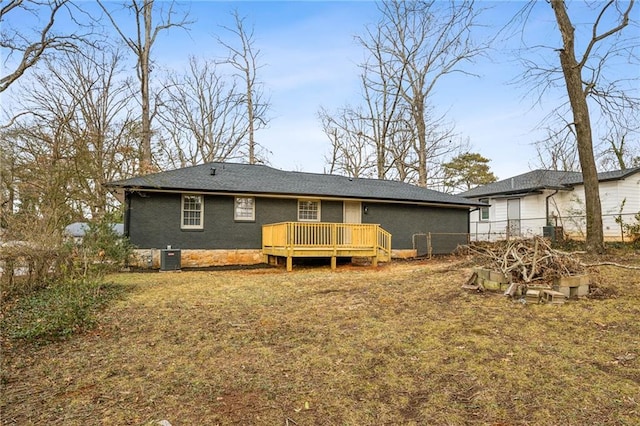 back of house featuring a yard and a deck