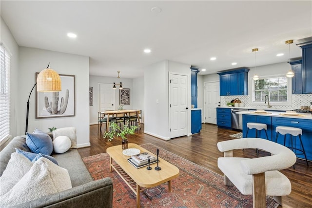 living room featuring dark hardwood / wood-style floors and sink