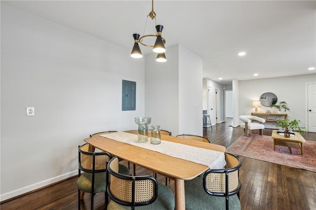 dining room featuring a notable chandelier, dark wood-type flooring, and electric panel