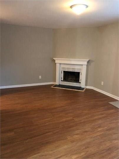 776 Crestside Ct, Austell, GA 30168 - unfurnished living room featuring dark wood-type flooring and a glass covered fireplace