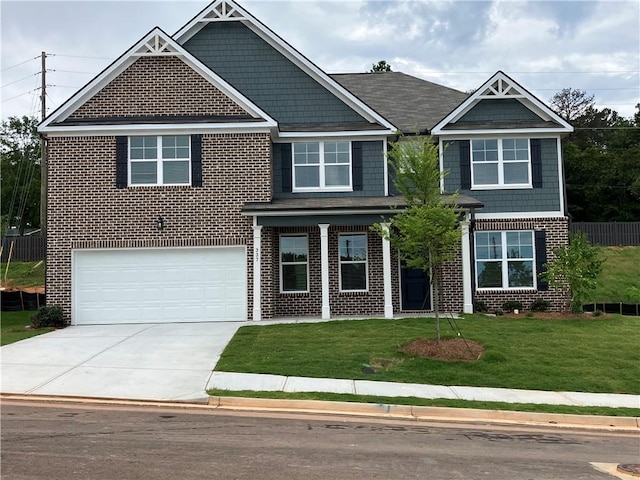 craftsman-style home featuring a front lawn and a garage