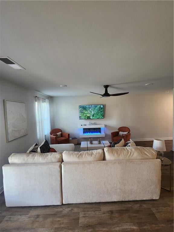4839 Station Ln, Union City, GA 30349 - living area with a fireplace, wood finished floors, and a ceiling fan