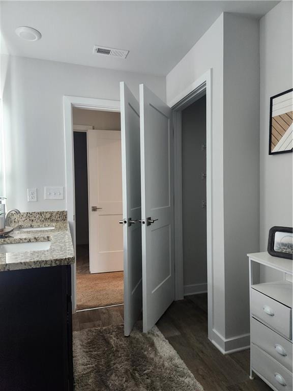 4839 Station Ln, Union City, GA 30349 - bathroom featuring wood finished floors, baseboards, and vanity