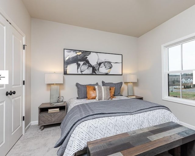 carpeted bedroom with baseboards