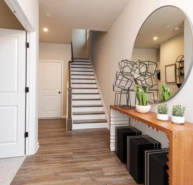 staircase featuring recessed lighting and wood finished floors