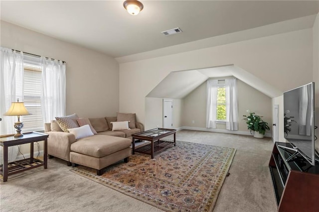 carpeted living room with lofted ceiling, visible vents, and baseboards