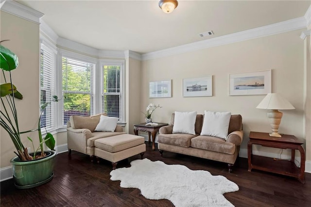 living area with ornamental molding, dark wood finished floors, visible vents, and baseboards