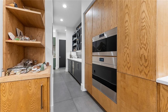 kitchen with light tile patterned floors and double oven