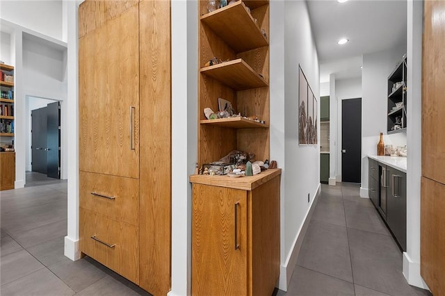 hallway with tile patterned flooring and built in features