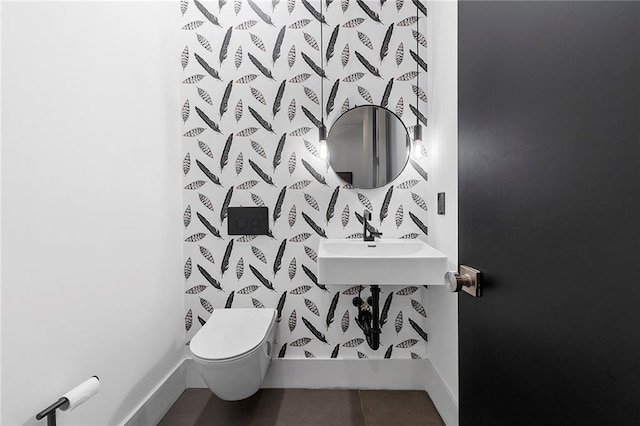 bathroom with sink, toilet, and tile patterned flooring