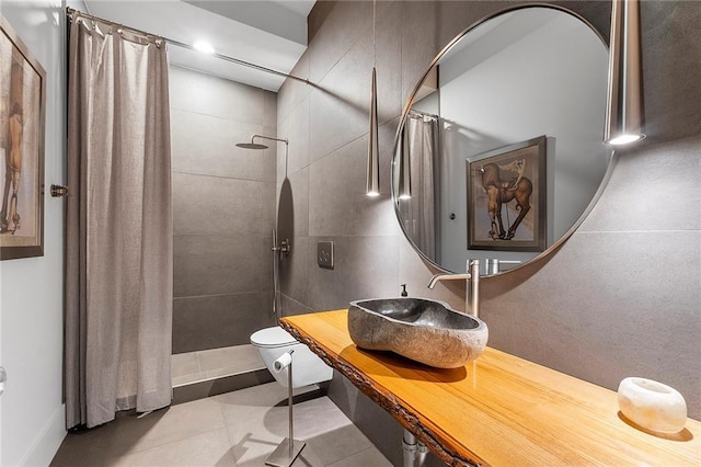 bathroom with toilet, sink, tile patterned floors, and a shower with curtain