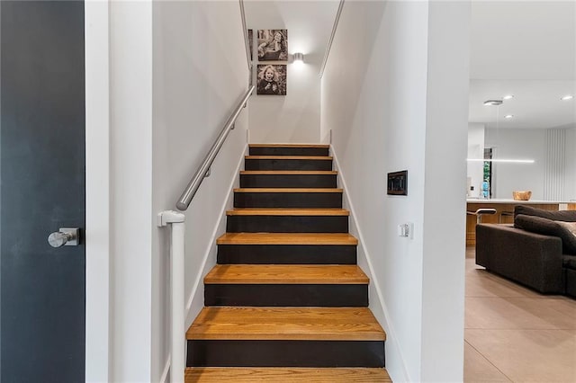 stairway featuring tile patterned floors