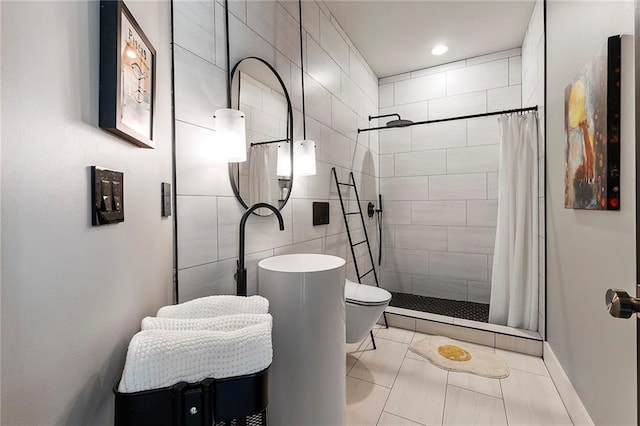 bathroom with walk in shower, toilet, tile patterned flooring, and tile walls