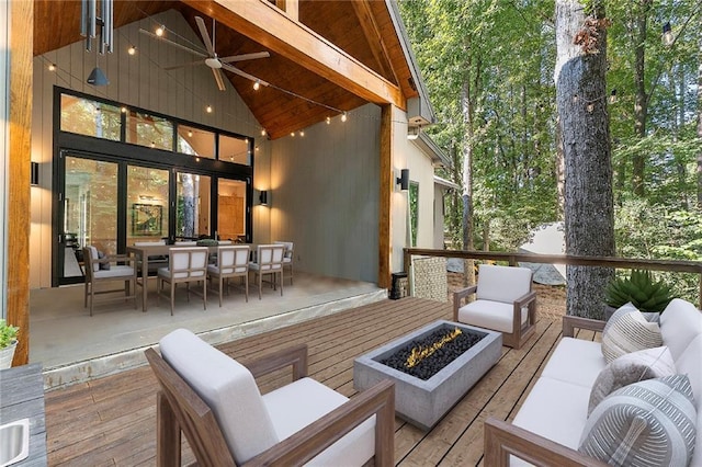 wooden deck featuring an outdoor living space with a fire pit and ceiling fan