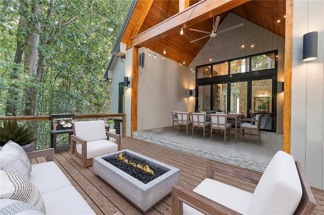 wooden deck featuring an outdoor living space with a fire pit and ceiling fan