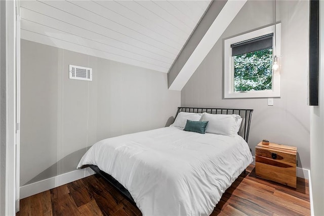 bedroom with vaulted ceiling and hardwood / wood-style floors