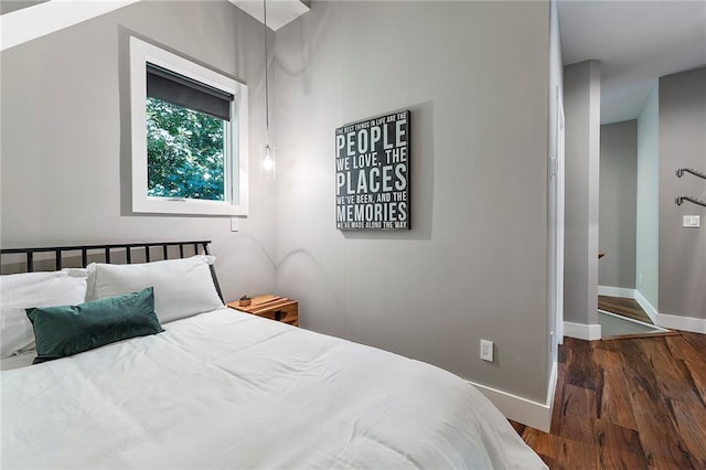 bedroom with dark hardwood / wood-style floors