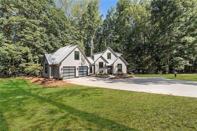 view of front of house with a garage and a front lawn