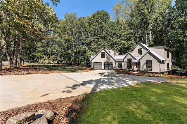 view of front of home with a garage and a front yard