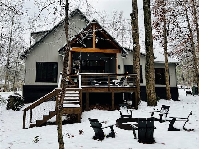 view of front of property with a deck and a fire pit