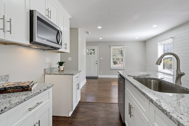 kitchen featuring white cabinetry, sink, a wealth of natural light, and appliances with stainless steel finishes