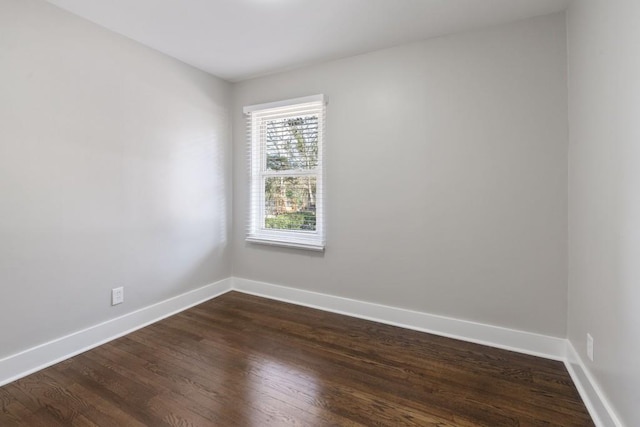 spare room with dark hardwood / wood-style floors