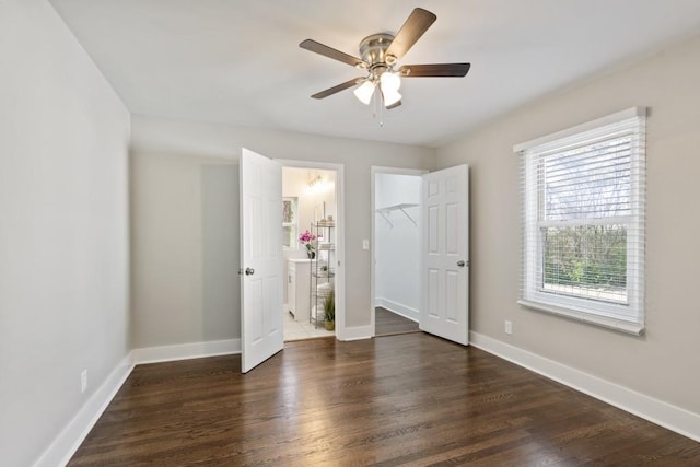 unfurnished bedroom featuring ceiling fan and dark hardwood / wood-style flooring