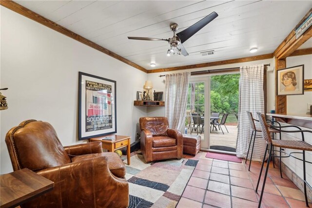 living area with crown molding, ceiling fan, wooden ceiling, and light tile patterned floors