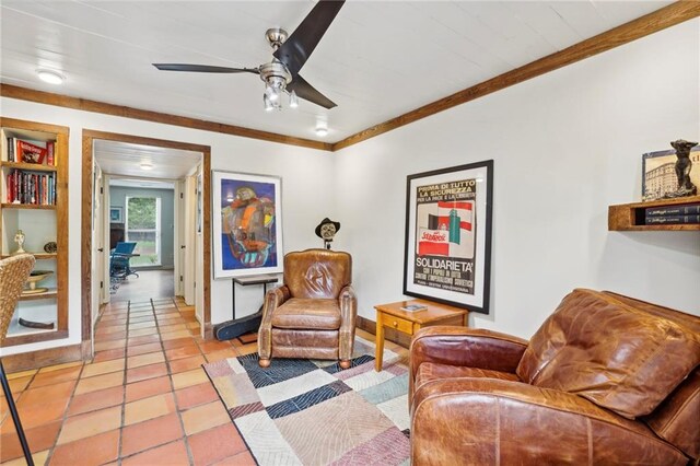 living area featuring ornamental molding, ceiling fan, and light tile patterned floors