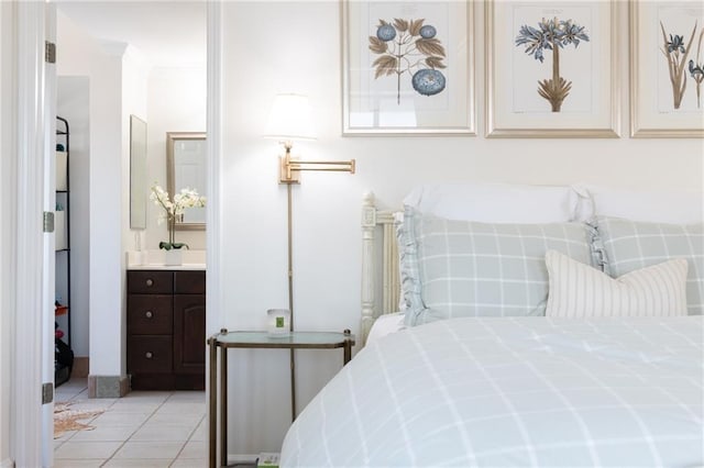 bedroom featuring ensuite bathroom and light tile patterned flooring