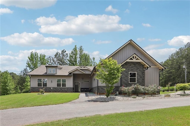 411 Johnson Rd, Locust Grove, GA 30248 - craftsman-style house with stone siding, a front yard, and board and batten siding