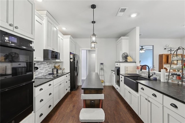 411 Johnson Rd, Locust Grove, GA 30248 - kitchen featuring black appliances, dark countertops, ceiling fan, backsplash, and white cabinets