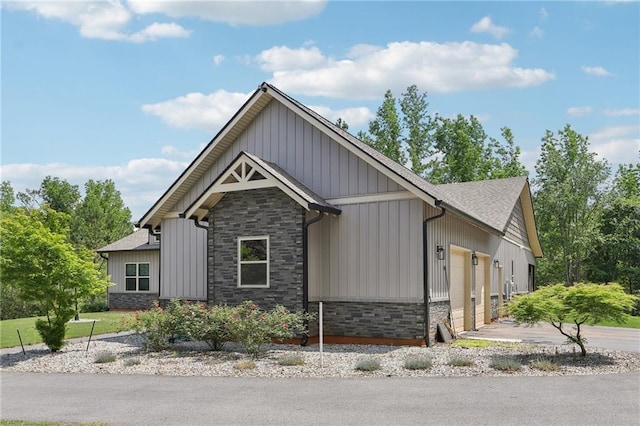 411 Johnson Rd, Locust Grove, GA 30248 - view of front of home featuring stone siding, board and batten siding, a garage, and a shingled roof