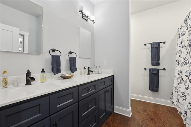 411 Johnson Rd, Locust Grove, GA 30248 - full bathroom with double vanity, wood finished floors, and a shower with shower curtain