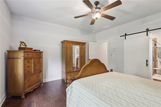 411 Johnson Rd, Locust Grove, GA 30248 - bedroom featuring dark wood-style flooring, a barn door, and a ceiling fan