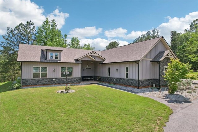 411 Johnson Rd, Locust Grove, GA 30248 - craftsman inspired home featuring stone siding, a front lawn, a shingled roof, and board and batten siding