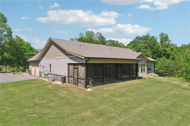 411 Johnson Rd, Locust Grove, GA 30248 - back of house with a sunroom, a yard, and driveway